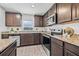 Kitchen features stainless steel appliances, granite countertops, and wooden cabinets at 5429 Companion Ln, Tampa, FL 33619