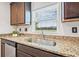 Bright kitchen sink area featuring granite counters with backyard views at 5429 Companion Ln, Tampa, FL 33619