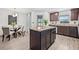 Kitchen island complements the adjacent dining area with backyard views from the sliding glass door at 5429 Companion Ln, Tampa, FL 33619