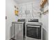 A spacious laundry room with a washer, dryer, shelving, and an ample space for laundry work at 5429 Companion Ln, Tampa, FL 33619