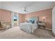 Inviting main bedroom with neutral carpet, natural light, and a ceiling fan at 5429 Companion Ln, Tampa, FL 33619