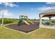 Community playground with slides, climbing structures, picnic tables and gazebo in a landscaped park setting at 5429 Companion Ln, Tampa, FL 33619
