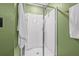 A view of the shower with a glass door, shower head, and a towel rack outside of the shower at 5429 Companion Ln, Tampa, FL 33619