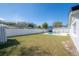 Spacious backyard featuring a pool, green lawn, and a white privacy fence at 6765 Ralston Beach Cir, Tampa, FL 33614