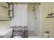 Modern bathroom features white shower and decorative shelving above the toilet at 6765 Ralston Beach Cir, Tampa, FL 33614