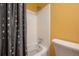 Bathroom with a shower/tub combination, white tile, and a modern shower head at 6765 Ralston Beach Cir, Tampa, FL 33614