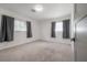 Bedroom with neutral carpet and two windows dressed in dark drapes at 6765 Ralston Beach Cir, Tampa, FL 33614