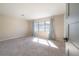 Bright bedroom featuring neutral paint, large window with curtains, and plush carpet at 6765 Ralston Beach Cir, Tampa, FL 33614