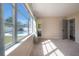 Sunlit bedroom with view of a pool outside of a large picture window at 6765 Ralston Beach Cir, Tampa, FL 33614