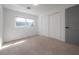 Bedroom features neutral carpet, closet with sliding doors, and a window at 6765 Ralston Beach Cir, Tampa, FL 33614