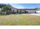 Lovely single-story home with lush green lawn, featuring a charming front facade at 6765 Ralston Beach Cir, Tampa, FL 33614