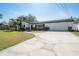 Charming single-story home with well-manicured lawn and long driveway at 6765 Ralston Beach Cir, Tampa, FL 33614