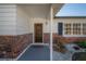 Inviting covered porch with a stylish front door and decorative brick accents at 6765 Ralston Beach Cir, Tampa, FL 33614