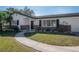 Single story home featuring brick accents and beautiful landscaping in the front yard at 6765 Ralston Beach Cir, Tampa, FL 33614