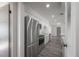 Renovated kitchen with stainless steel appliances, white cabinets and gorgeous gray luxury vinyl plank flooring at 6765 Ralston Beach Cir, Tampa, FL 33614