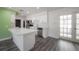 Eat-in kitchen with stainless appliances, white cabinets and gray luxury vinyl plank flooring and French doors at 6765 Ralston Beach Cir, Tampa, FL 33614