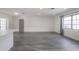 Spacious living room with wood flooring, gray walls, and a large window at 6765 Ralston Beach Cir, Tampa, FL 33614