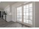 Living area view showcases white cabinets, stainless steel appliances, gray flooring and French doors at 6765 Ralston Beach Cir, Tampa, FL 33614