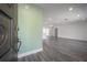 Bright, open-concept living space with modern gray wood flooring and plenty of natural light at 6765 Ralston Beach Cir, Tampa, FL 33614