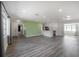 Open floor plan with gray wood flooring, bright, and well lit with stainless steel appliances at 6765 Ralston Beach Cir, Tampa, FL 33614