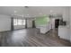 Spacious open floor plan features gray wood flooring and a bright living room at 6765 Ralston Beach Cir, Tampa, FL 33614