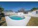 Backyard pool area with patio, white concrete coping, and a glimpse of green lawn at 6765 Ralston Beach Cir, Tampa, FL 33614