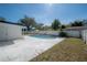 Backyard pool area with a white fence and a green lawn at 6765 Ralston Beach Cir, Tampa, FL 33614