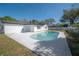 The backyard has a refreshing pool, white privacy fence and well maintained lawn at 6765 Ralston Beach Cir, Tampa, FL 33614