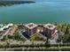Stunning aerial view of waterfront condo buildings, showcasing manicured grounds and beautiful water views at 7430 Sunshine Skyway S Ln # 403, St Petersburg, FL 33711
