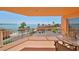 Balcony view showcasing the pool, palm trees, and beautiful ocean at 7430 Sunshine Skyway S Ln # 403, St Petersburg, FL 33711