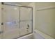 This bathroom features a shower-tub with sliding glass doors and standard toilet at 7430 Sunshine Skyway S Ln # 403, St Petersburg, FL 33711
