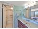 Bathroom features a sink vanity and combined shower and tub with sliding glass doors at 7430 Sunshine Skyway S Ln # 403, St Petersburg, FL 33711