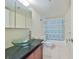 This bathroom has a modern glass sink and vanity at 7430 Sunshine Skyway S Ln # 403, St Petersburg, FL 33711