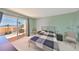 Bright bedroom features a sliding glass door leading to a balcony with ocean views at 7430 Sunshine Skyway S Ln # 403, St Petersburg, FL 33711