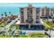 Stunning beachfront condo building with covered parking, palm trees, and direct ocean access at 7430 Sunshine Skyway S Ln # 403, St Petersburg, FL 33711