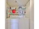 Laundry closet area with shelving and stacked full size washer and dryer at 7430 Sunshine Skyway S Ln # 403, St Petersburg, FL 33711