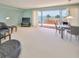 Spacious living area with comfortable seating and access to a balcony overlooking the ocean at 7430 Sunshine Skyway S Ln # 403, St Petersburg, FL 33711