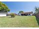 Large fenced backyard with lush lawn, shed, and covered patio for outdoor enjoyment at 747 Stillview Cir, Brandon, FL 33510