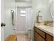 Bright bathroom with tiled walk-in shower, sink, and wood cabinet at 747 Stillview Cir, Brandon, FL 33510