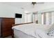 Comfortable bedroom features classic wood furniture, closet space, and a ceiling fan at 747 Stillview Cir, Brandon, FL 33510