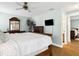 Comfortable bedroom with wood furniture, a ceiling fan, and an ensuite bath at 747 Stillview Cir, Brandon, FL 33510