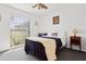Comfortable bedroom with a ceiling fan, a bright window, and neutral décor at 747 Stillview Cir, Brandon, FL 33510