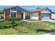 Charming single-story home features a brick facade and well-maintained front lawn with stepping stones at 747 Stillview Cir, Brandon, FL 33510