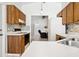 Well-lit kitchen with wood cabinets, white countertops, and stainless steel sink for a functional cooking space at 747 Stillview Cir, Brandon, FL 33510