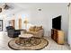 Open-concept living room with neutral walls, tiled floors, a decorative rug, and comfortable seating arrangements at 747 Stillview Cir, Brandon, FL 33510