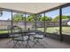 Covered outdoor patio with black metal table and chairs overlooking the yard at 747 Stillview Cir, Brandon, FL 33510