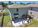 This aerial view shows a house with a backyard featuring a patio, pergola, and swing set at 7591 Cypress Walk Dr, New Port Richey, FL 34655