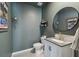 Well-decorated half bath with a stylish vanity, round mirror, and modern fixtures for a touch of elegance at 7591 Cypress Walk Dr, New Port Richey, FL 34655