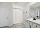 Bright bathroom with a shower-tub combo, single vanity, and white cabinets at 7591 Cypress Walk Dr, New Port Richey, FL 34655