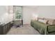 This bedroom includes a work space with a comfortable daybed and natural light at 7591 Cypress Walk Dr, New Port Richey, FL 34655